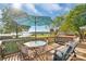 Deck with an umbrella-covered table and chairs with scenic lake view at 421 Tranquil Bay Cir, Norwood, NC 28128