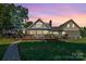 Stunning home showcasing a spacious deck, complemented by manicured lawn, hardscape patio and a gazebo at 421 Tranquil Bay Cir, Norwood, NC 28128