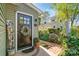 Inviting front door with a decorative wreath, complemented by a beautiful garden and a welcoming walkway at 421 Tranquil Bay Cir, Norwood, NC 28128