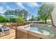 Relaxing hot tub on a deck overlooking the lush backyard at 421 Tranquil Bay Cir, Norwood, NC 28128