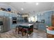 Bright kitchen with stainless appliances, island seating, and modern design elements at 421 Tranquil Bay Cir, Norwood, NC 28128