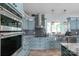 Updated kitchen features stainless appliances, custom cabinets, and modern lighting at 421 Tranquil Bay Cir, Norwood, NC 28128