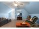 Cozy living room with blue walls, plush seating, carpet, and ceiling fan at 421 Tranquil Bay Cir, Norwood, NC 28128