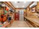 Spacious storage room with wood paneling, built-in shelves, gun safe, and laminate flooring at 421 Tranquil Bay Cir, Norwood, NC 28128