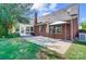 Backyard features a brick house with a patio and well-maintained lawn at 4302 Ethel Sustar Dr, Monroe, NC 28110