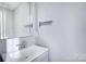 Well-lit bathroom with gray vanity, large mirror, and a chrome faucet at 4302 Ethel Sustar Dr, Monroe, NC 28110