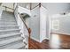 A spacious foyer with hardwood floors and staircase leads to the upper level, showcasing an inviting home entrance at 4302 Ethel Sustar Dr, Monroe, NC 28110