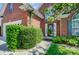 Brick home featuring a welcoming front entrance with a garden and well-manicured lawn and lush landscaping at 4302 Ethel Sustar Dr, Monroe, NC 28110