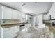 Spacious kitchen with white cabinetry, tile floors, granite countertops, and stainless steel appliances at 4302 Ethel Sustar Dr, Monroe, NC 28110