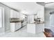 A well-lit, white kitchen featuring granite countertops, stainless steel appliances, and tile flooring at 4302 Ethel Sustar Dr, Monroe, NC 28110