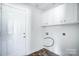 Bright laundry room with overhead storage cabinets and tile floor at 4302 Ethel Sustar Dr, Monroe, NC 28110