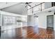 Bright open-concept living room with vaulted ceilings, wood floors, access to the kitchen, and natural light at 4302 Ethel Sustar Dr, Monroe, NC 28110