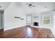 Light-filled living room with vaulted ceilings, wood floors, fireplace, and white stone surround at 4302 Ethel Sustar Dr, Monroe, NC 28110