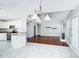 Open concept living room with white cabinets, stainless appliances, and tile/wood flooring at 4302 Ethel Sustar Dr, Monroe, NC 28110
