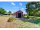 Charming brick outbuilding with a weather vane, black door, and a small, white picket fence at 4302 Ethel Sustar Dr, Monroe, NC 28110