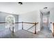 Upstairs hallway with a chandelier and natural light from large windows at 4302 Ethel Sustar Dr, Monroe, NC 28110