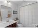 Bathroom with a modern vanity, framed mirror, toilet, and shower with curtain at 4318 Greenleaf Nw St, Concord, NC 28027