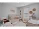 Bright Bedroom with a crib, chair, window, and decorative wall art at 4318 Greenleaf Nw St, Concord, NC 28027