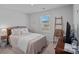 Cozy bedroom featuring neutral colors, a window, and a comfortable bed with decorative pillows at 4318 Greenleaf Nw St, Concord, NC 28027