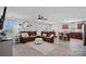 Open concept living room seamlessly connects to the kitchen, featuring hardwood floors and a ceiling fan at 4318 Greenleaf Nw St, Concord, NC 28027