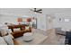 Spacious living room showcasing hardwood floors, modern decor, and seamless flow to kitchen and entryway at 4318 Greenleaf Nw St, Concord, NC 28027