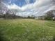 Expansive vacant land with fresh green grass, perfect for constructing a custom dream home in an established neighborhood at 4349 Roberta Rd, Concord, NC 28027