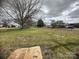A large empty lot with grass and bare trees on an overcast day presents a great space for building a home at 4349 Roberta Rd, Concord, NC 28027