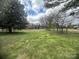 A grassy residential building lot, dotted with trees and surrounded by a peaceful neighborhood offers lots of opportunity at 4349 Roberta Rd, Concord, NC 28027
