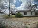 Home showing mature trees and a charming vintage storage building at 4349 Roberta Rd, Concord, NC 28027