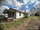 Home's side view showing a cozy porch and brick foundation details at 4349 Roberta Rd, Concord, NC 28027