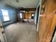 A living room needing repair and renovation features unfinished walls and hardwood floors at 4349 Roberta Rd, Concord, NC 28027
