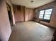 This room is shown gutted, down to studs with exposed flooring, and is awaiting renovation at 4349 Roberta Rd, Concord, NC 28027