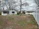 Spacious, partially fenced yard with mature trees around the house at 4349 Roberta Rd, Concord, NC 28027