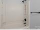 Neutral bathtub with shower head and caddy for bath products at 4515 Country Meadows Dr, Gastonia, NC 28056