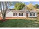 Beautiful exterior of a home with a manicured lawn, flowerbeds and mature trees in the front yard at 4515 Country Meadows Dr, Gastonia, NC 28056