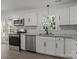 Well-lit kitchen showcases stainless steel appliances, white cabinets and stone countertops at 4515 Country Meadows Dr, Gastonia, NC 28056