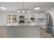 Bright kitchen features a large island, stainless steel appliances, granite countertops, and white cabinets at 4515 Country Meadows Dr, Gastonia, NC 28056