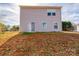 Exterior back of home features neutral siding, a sliding glass door and grassy knoll at 4852 Stone Dr, Conover, NC 28613