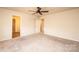Bedroom with carpet, ceiling fan, and access to a bathroom and closet at 4852 Stone Dr, Conover, NC 28613
