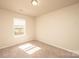 This basic bedroom has neutral walls and carpet and a window for natural light at 4852 Stone Dr, Conover, NC 28613