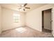 This bedroom features neutral walls and carpet, along with a ceiling fan and a door to the ensuite at 4852 Stone Dr, Conover, NC 28613