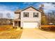 Beautiful two-story home with a well-manicured front yard and attached two-car garage at 4852 Stone Dr, Conover, NC 28613