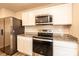 Modern kitchen featuring stainless steel appliances, granite countertops, and stylish white cabinetry at 4852 Stone Dr, Conover, NC 28613