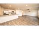 Open-concept kitchen and living area featuring wood-look flooring and stainless steel appliances at 4852 Stone Dr, Conover, NC 28613