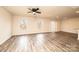 Bright living room features hardwood floors, a ceiling fan, and natural light from the double windows at 4852 Stone Dr, Conover, NC 28613