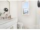 Stylish bathroom with a sleek vanity, modern fixtures, elegant mirror, and a toilet at 5108 Potter Rd, Matthews, NC 28104