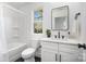 A modern bathroom featuring a sleek white vanity, black hardware, and a combined tub and shower at 5108 Potter Rd, Matthews, NC 28104