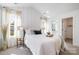Bright bedroom with a white walls, carpet, and natural light streaming through the windows at 5108 Potter Rd, Matthews, NC 28104