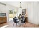 Modern dining area with stylish table, elegant lighting, and sliding glass doors to the outside at 5108 Potter Rd, Matthews, NC 28104