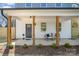 Inviting front porch with stylish seating, decorative plants, and modern design elements at 5108 Potter Rd, Matthews, NC 28104